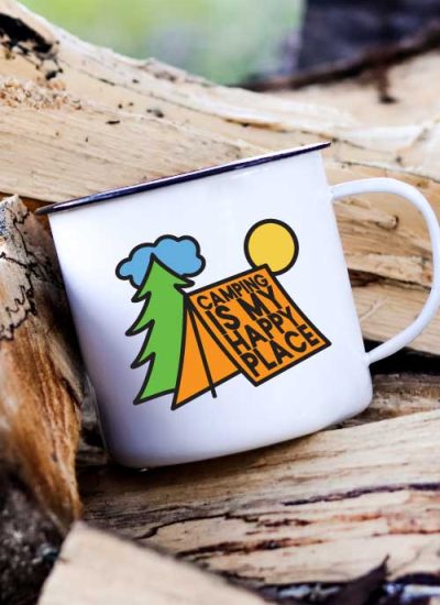 Camp Mug on a stack of wood with Camping is My Happy Place SVG in vinyl - Vertical