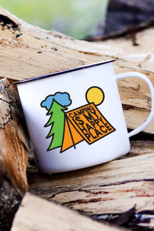 Camp Mug on a stack of wood with Camping is My Happy Place SVG in vinyl - Vertical