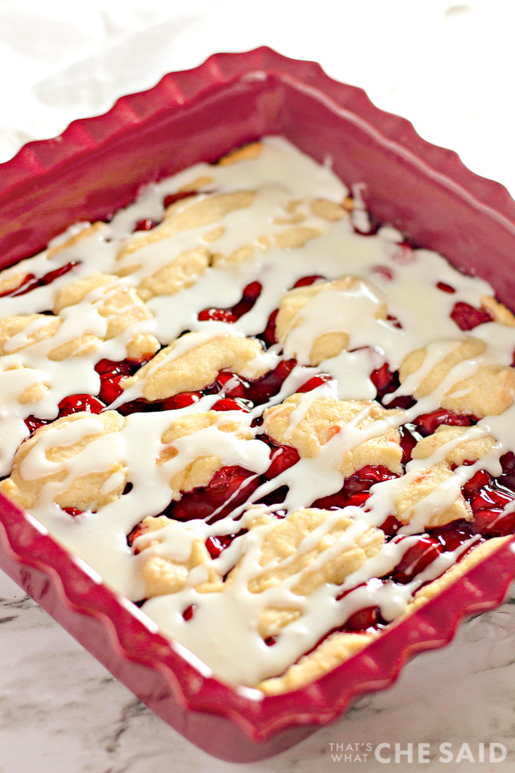 Homemade Cherry Bars in Baking Dish with frosting drizzle - Vertical Shot