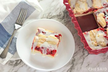 Cut cherry bar on white plate and pan of the rest in the background