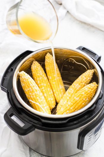 adding liquid to instant pot with corn
