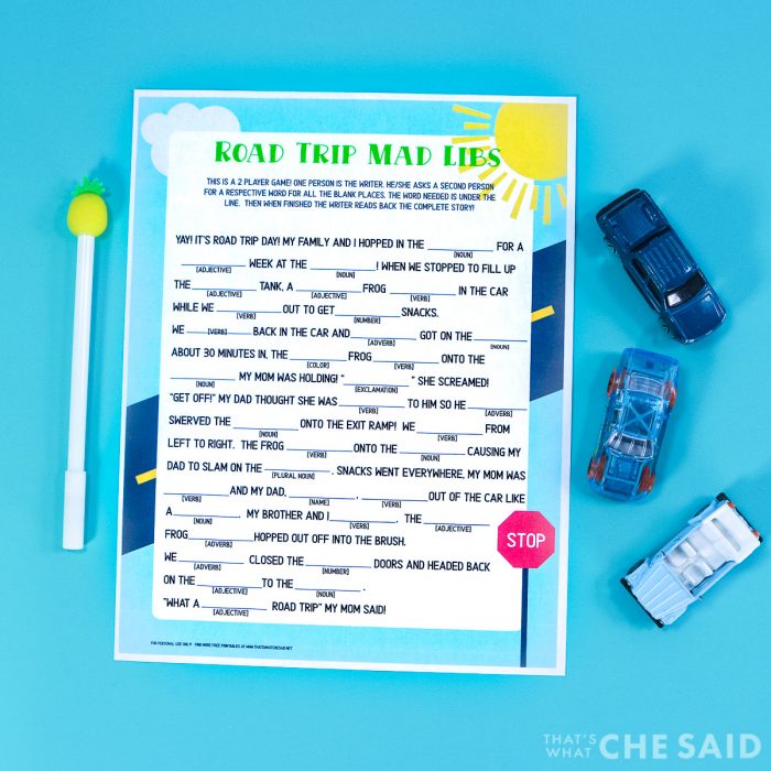 Blue background with Road Trip Mad Lib Printable and a pen and some matchbox cars Horizontal Format