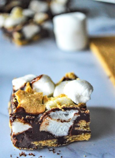 close up of smore fudge piece with ingredients in background