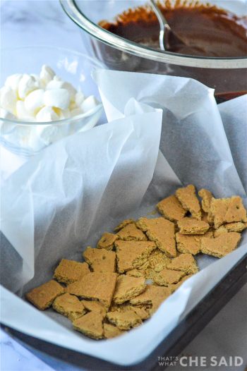 Graham cracker pieces in parchment lined loaf pan