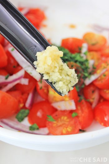 Adding minced garlic to relish