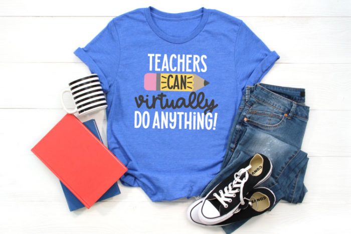 Blue T-shirt with jeans, converse, a coffee mug and folders that has the SVG File "Teachers Can Virtually Do Anything" in iron on in horizontal orientation