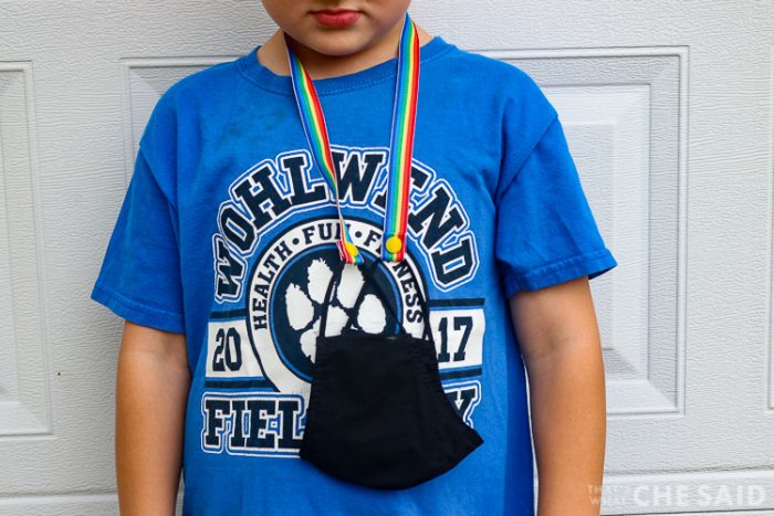 mask with mask lanyard hanging around a child's neck and body