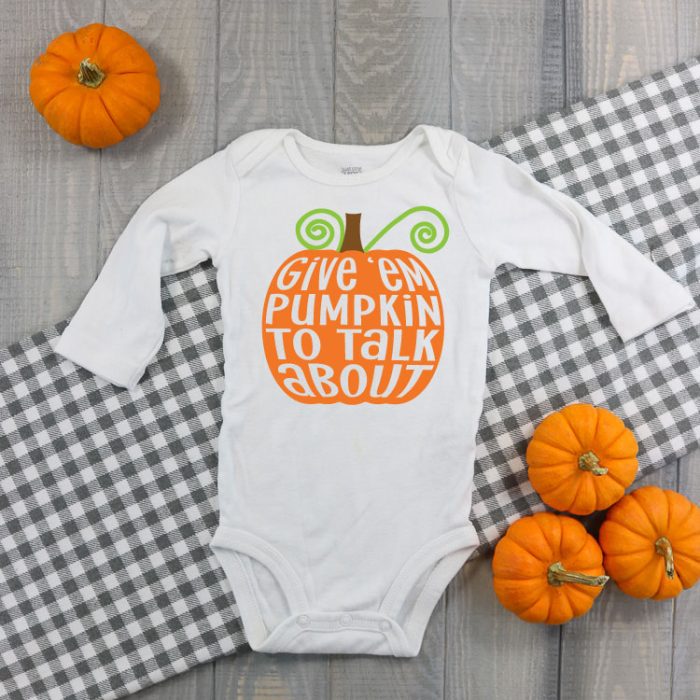 White baby bodysuit with "Give 'em pumpkin to talk about" in iron on.