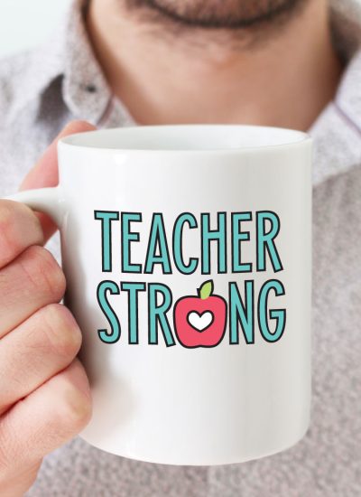 Man holding white coffee mug with "Teacher Strong" design in adhesive vinyl - vertical format