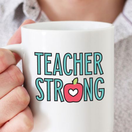 Man holding white coffee mug with "Teacher Strong" design in adhesive vinyl - vertical format