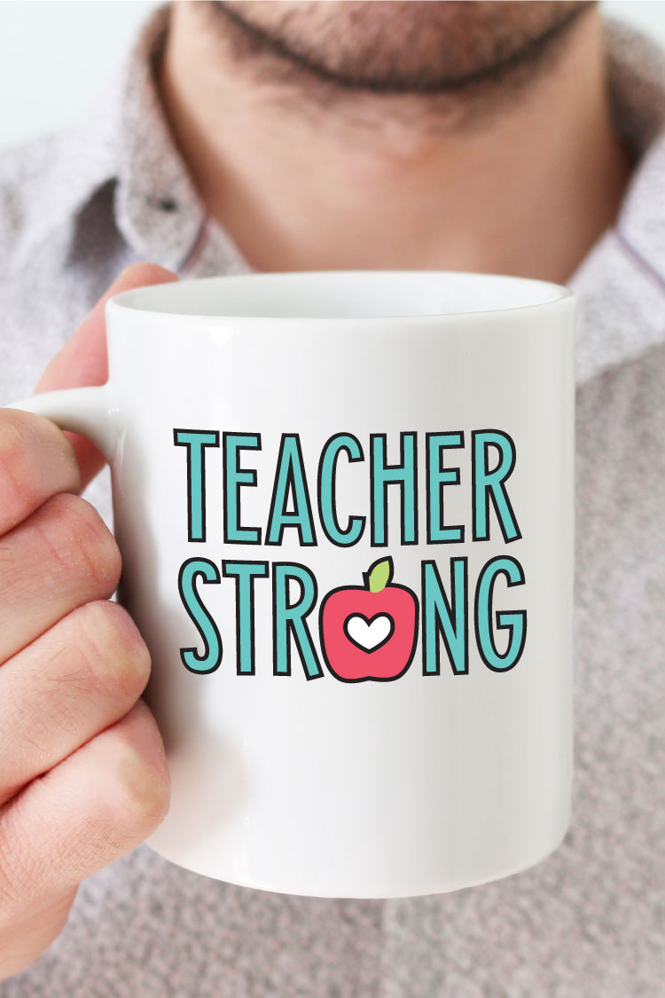 Man holding white coffee mug with "Teacher Strong" design in adhesive vinyl - vertical format