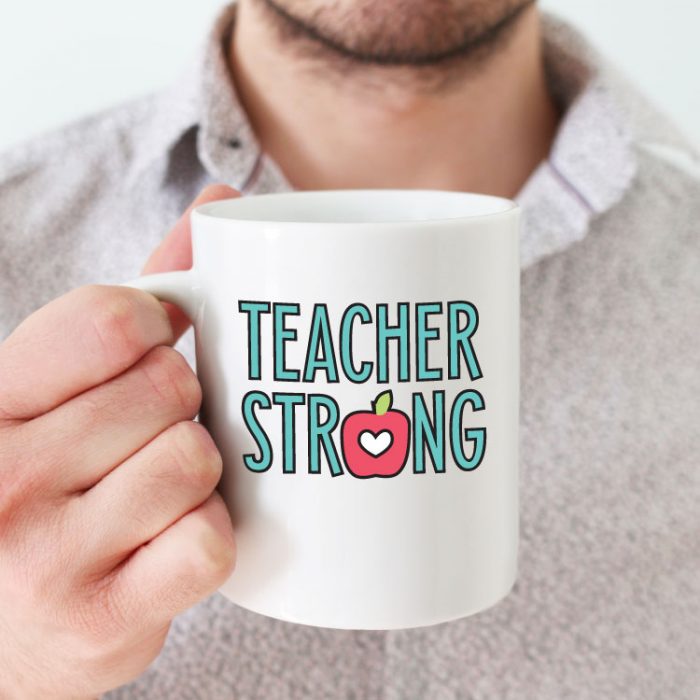 Man holding white coffee mug with "Teacher Strong" design in adhesive vinyl - square format
