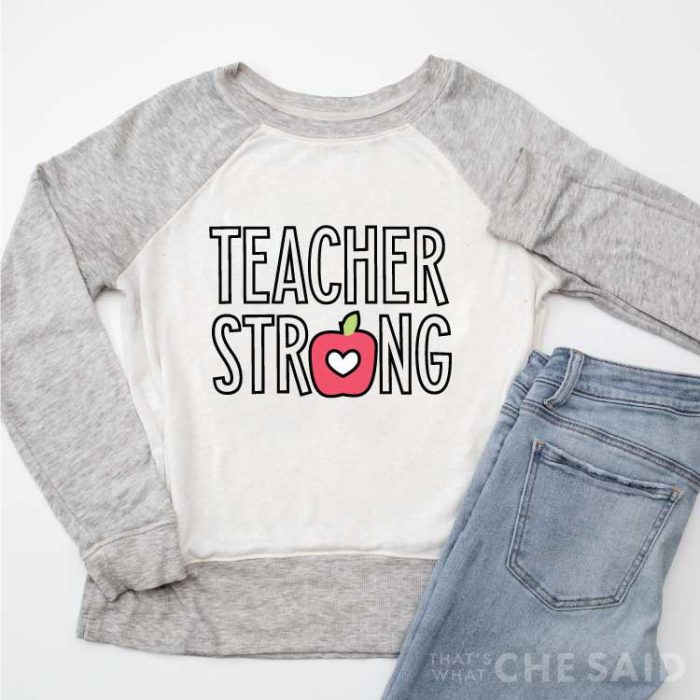 Raglan sweatshirt with grey sleeves and white body with "Teacher Strong" Design in Iron-on part of 14 free teacher svgs blog hop