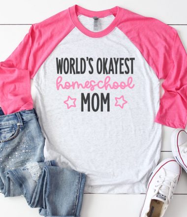 White Raglan T-shirt with Pink sleeves and jeans and sneakrs. Shirt reads "World's Okayest Homeschool Mom" in iron on vinyl - Square Format