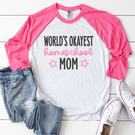 White Raglan T-shirt with Pink sleeves and jeans and sneakrs. Shirt reads "World's Okayest Homeschool Mom" in iron on vinyl - Square Format