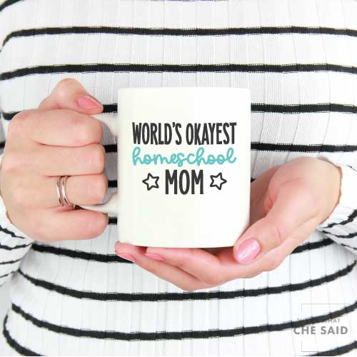 Woman holding Coffee Mug with "World's Okayest Homeschool Mom" applied with adhesive vinyl