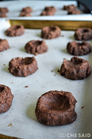 Dough Balls placed on parchment-lined baking sheet with centers indented