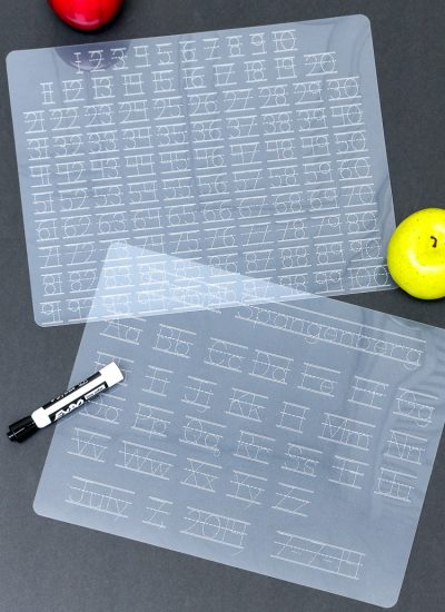 Dollar store plastic cutting mats turned Alpha and Numeric tracing mats using a Cricut Machine - Vertical shot both mats on black "chalkboard" background