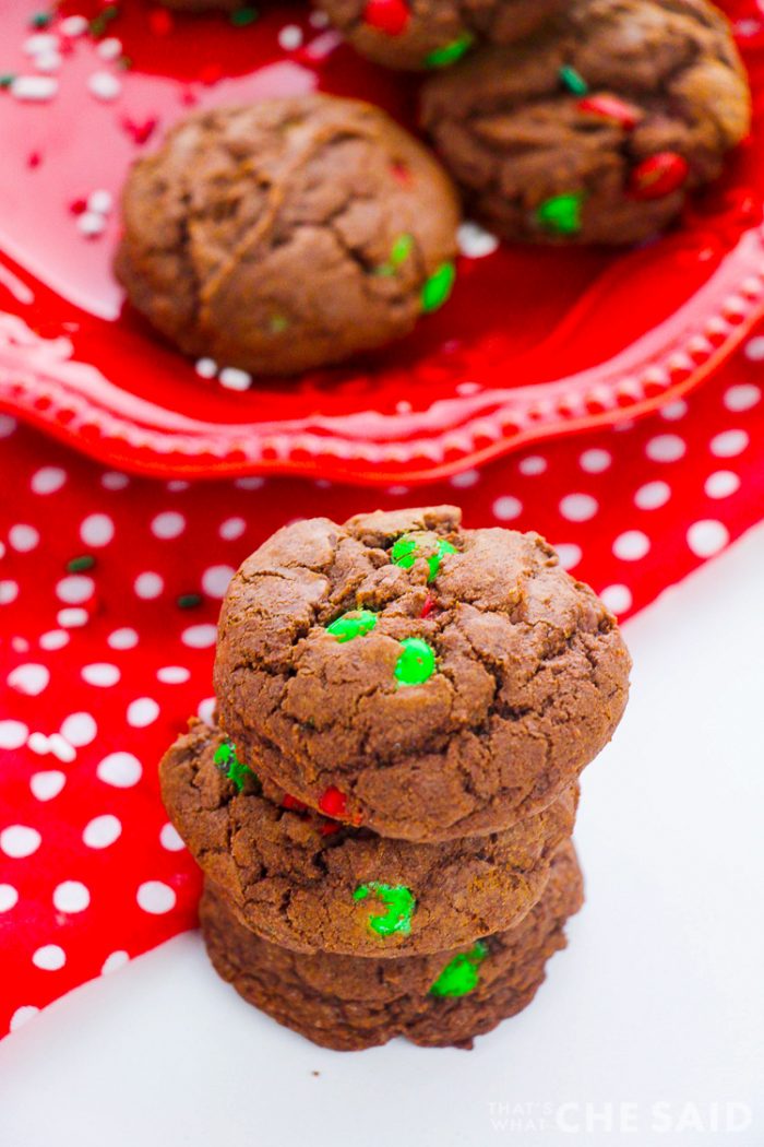 Plate of cookies in background and three stacked cookies in foreground