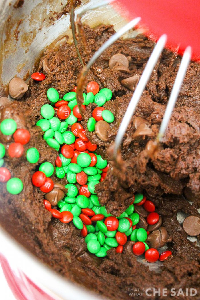 Shot of mixing bowl with chocolate cookie dough with added in chocolate chips and holiday m&M's