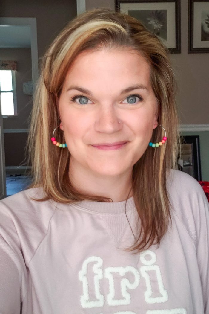 Cheryl modeling rainbow earrings