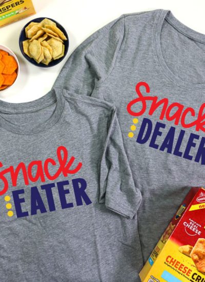 2 Grey shirts, adult shirt has Snack Dealer adn child shirt has snack eater in iron on vinyl