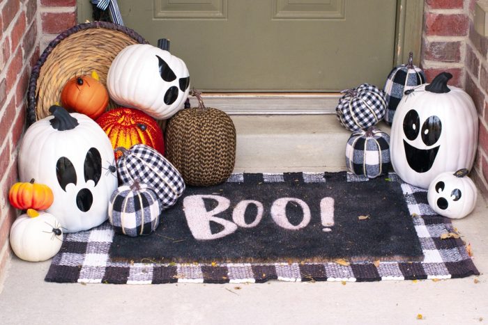 White pumpkins with black vinyl ghost faces