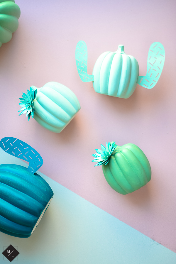 Pumpkins turned into cacti with paper arms and flowers and adhesive vinly prickles