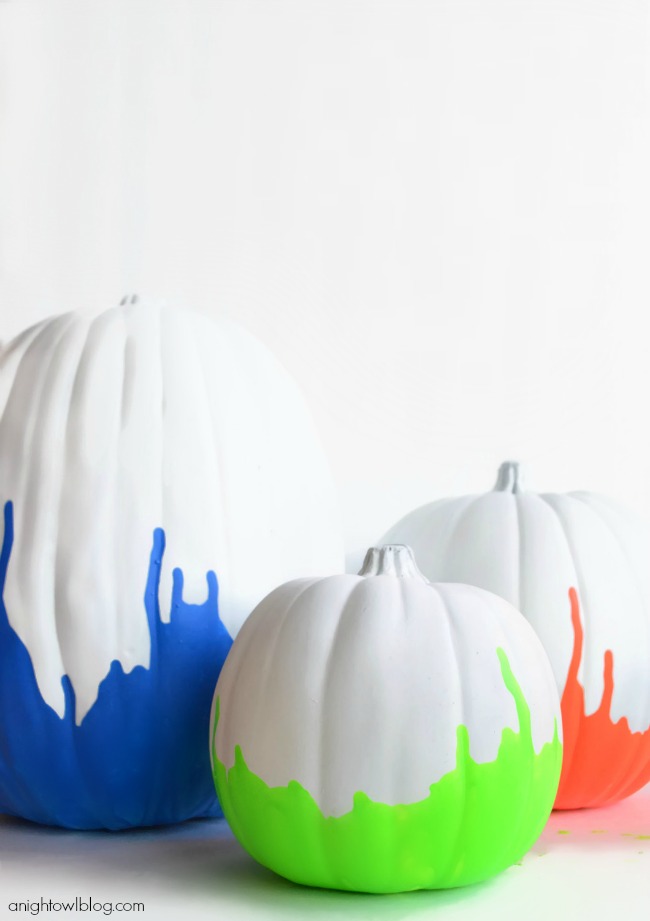 Pumpkins that have been painted white and dipped in neon paint