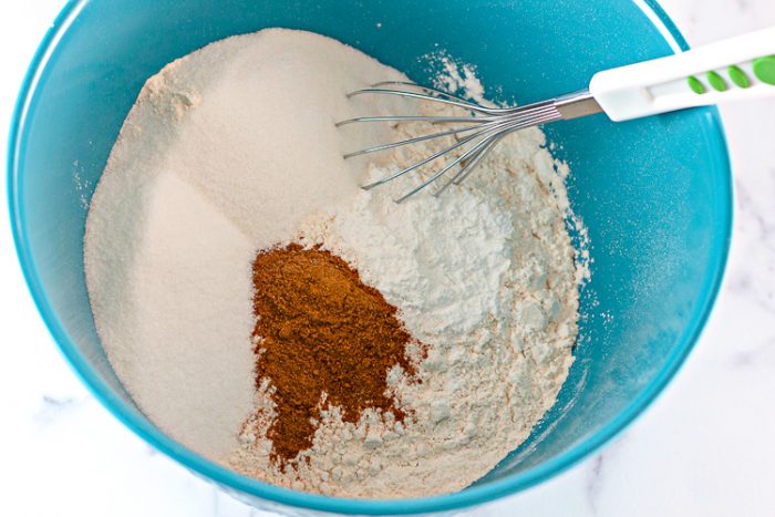 Blue bowl with dry pumpkin donut ingredients