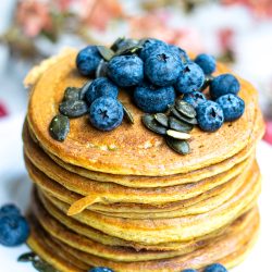Stacked Pumpkin Pancakes with Blueberries and Pumpkin seed topping