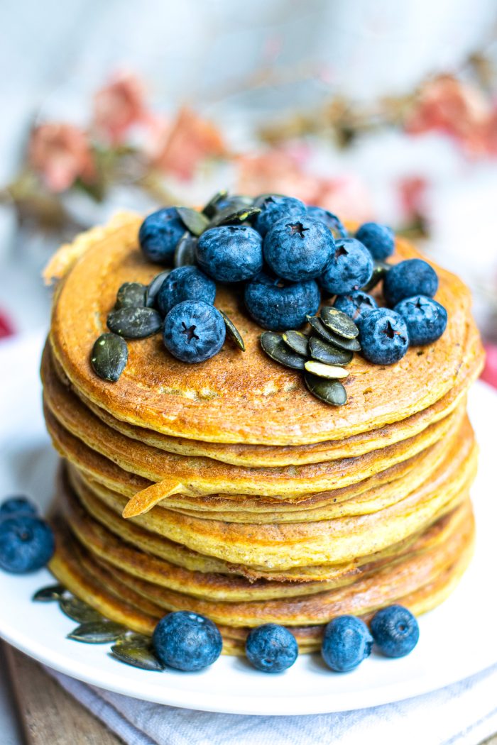 Stacked Pumpkin Pancakes with Blueberries and Pumpkin seed topping