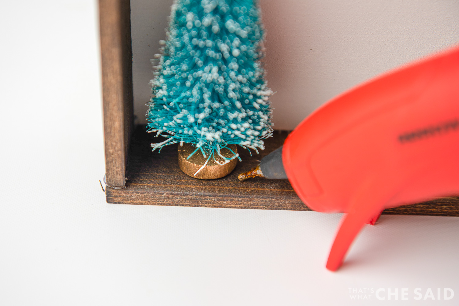 Hot gluing tree into sign