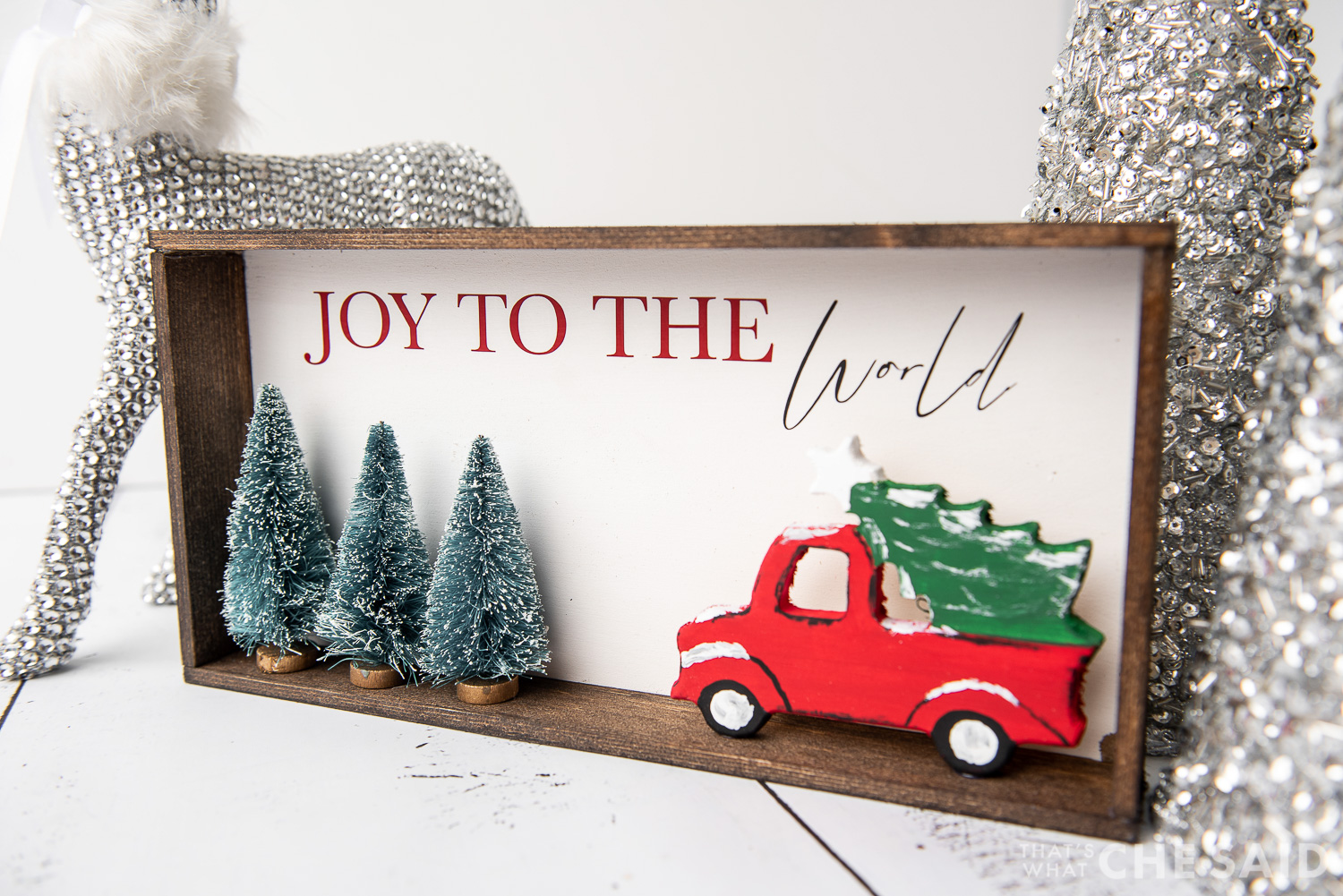 DIY Christmas Sign with Silver trees and deer in background - horizontal at slight angle