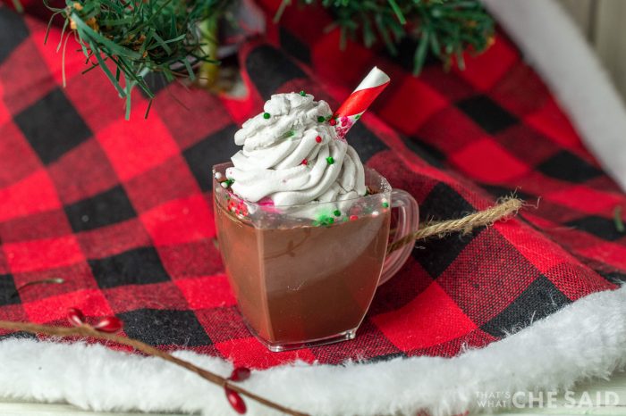 Dollar Store hot Chocolate ornament sitting on buffalo check tree skirt