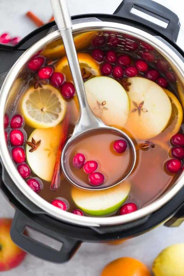 instant pot and apple cider with apples and cranberries