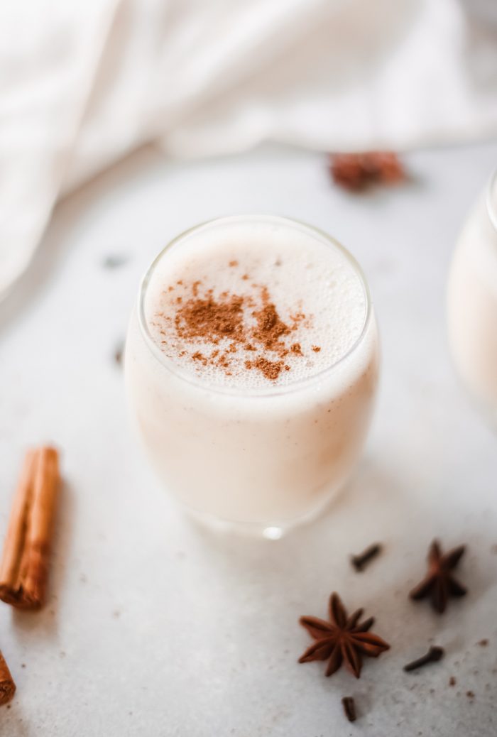 Instant pot egg nog in a stemless wine glass