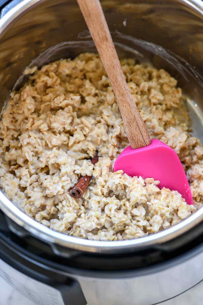 Instant pot inner pot with cooked oatmeal and spoon