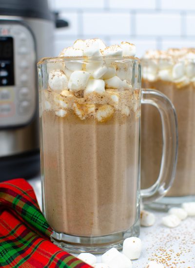Tuxedo Hot Chocolate in a tall glass mug with marshmallows on top. Another mug and Instant pot is in the background
