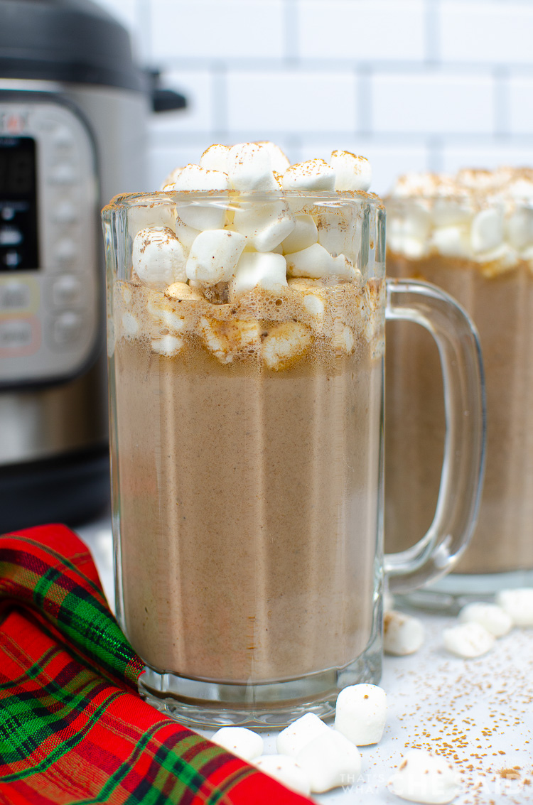Tuxedo Hot Chocolate in a tall glass mug with marshmallows on top. Another mug and Instant pot is in the background