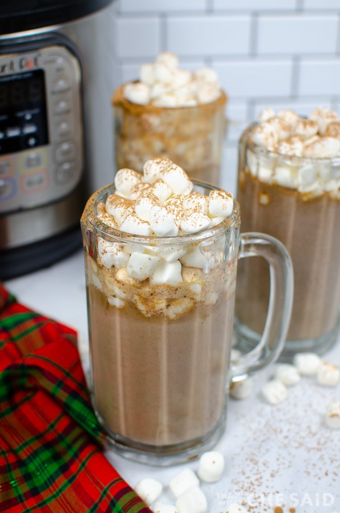 Vertical 45 degree view of 3 hot chocolate mugs with instant pot in the background