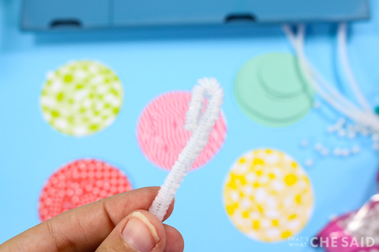 Close up of white pipe cleaner looped at the top