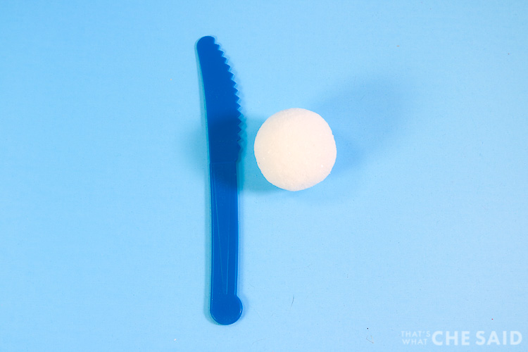 Styrofoam Ball and Styrofoam Knife on blue background