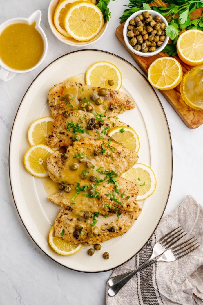 Chicken Picata on a white oval platter