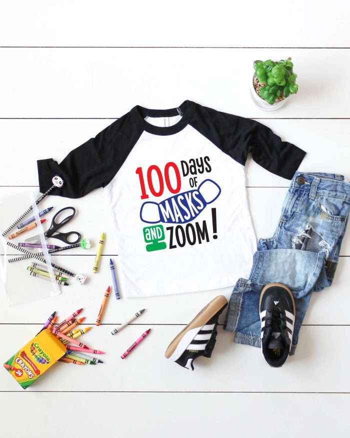 Vertical White background with black and white raglan t-shirt with 100 days of school design and school supplies