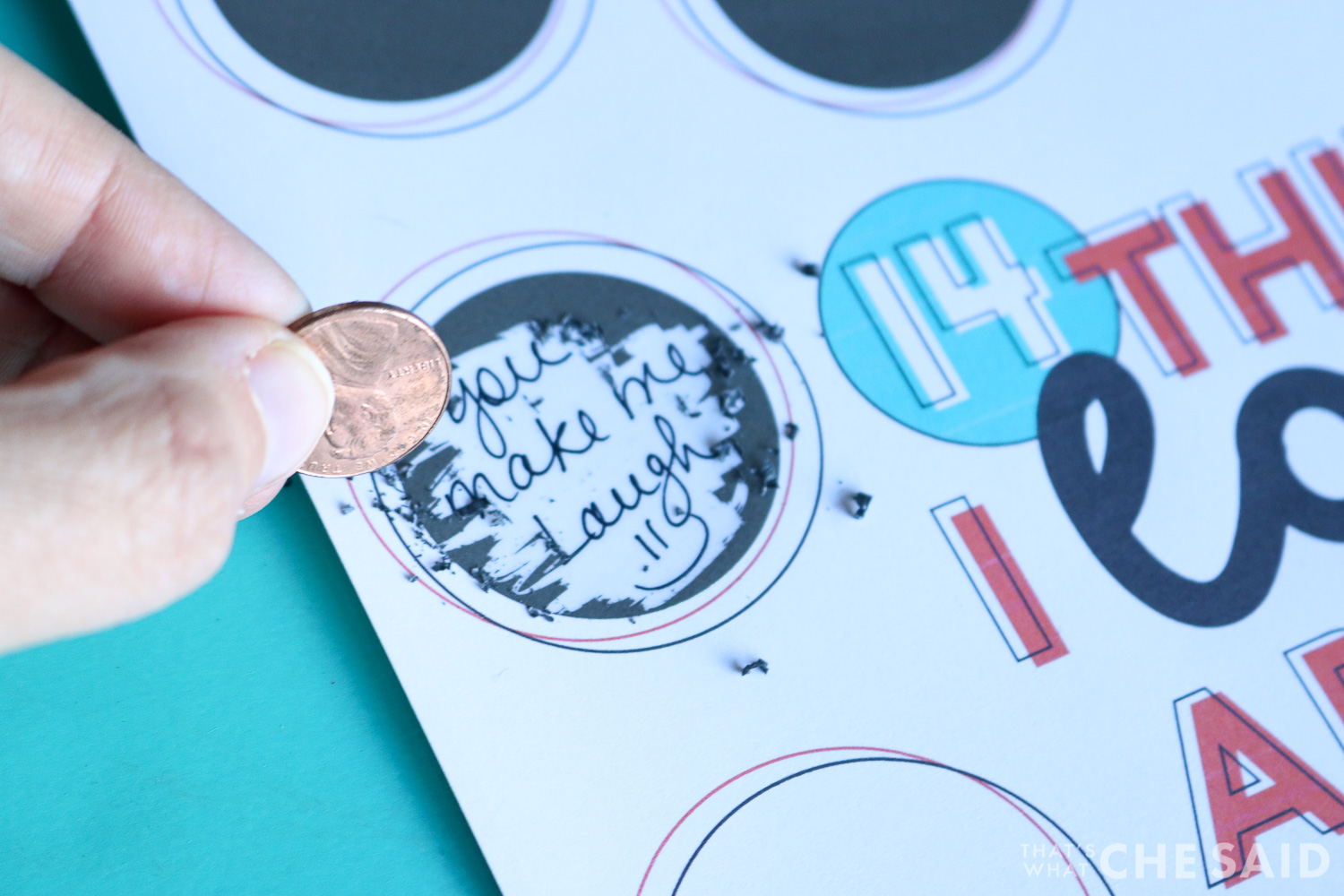 Close up of scratch off sticker being scratched off with a penny