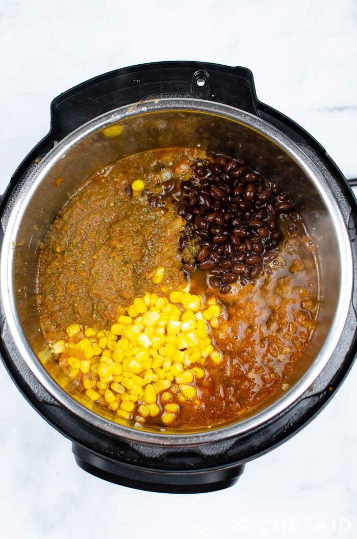 Ingredients added to instant pot inner bowl for chicken burrito bowls