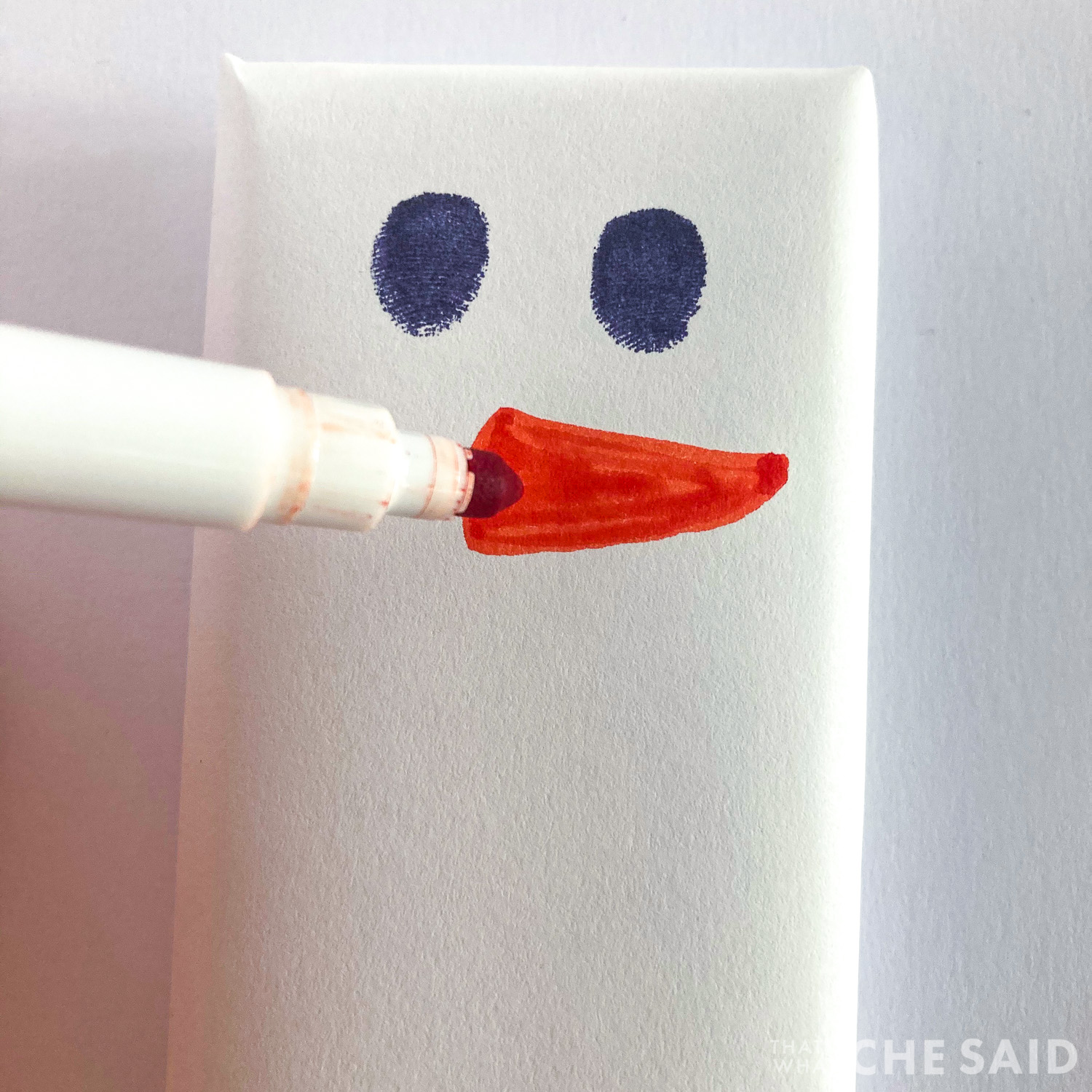 drawing the carrot nose with orange marker