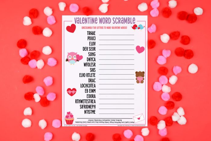 Red background with red, white and pink valentine pom poms and a Valentine Word Scramble printable in the center horizontal orientation