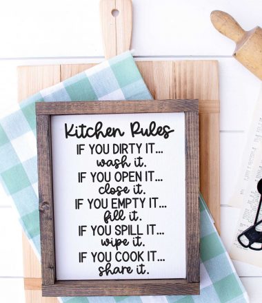 White wood with Cutting Board, kitchen towel, rolling pin and sign that has kitchen rules svg applied